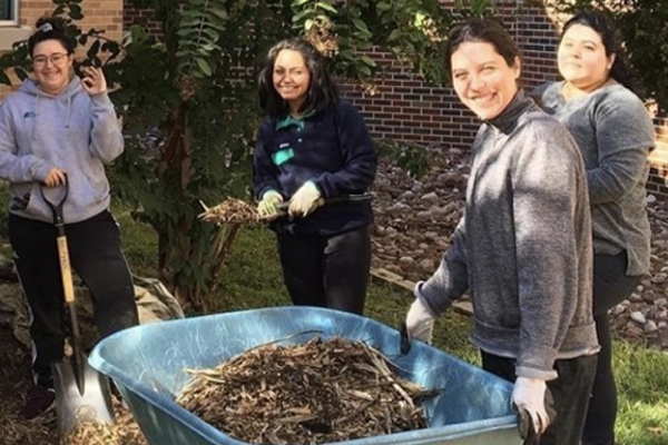 students gathered doing yard work